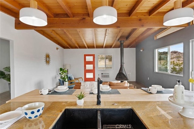 52024 Nehlsen Rd, Johnson Valley, CA 92285 - kitchen featuring a wood stove, wooden ceiling, a sink, and beam ceiling