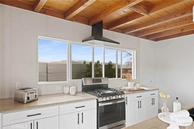 52024 Nehlsen Rd, Johnson Valley, CA 92285 - kitchen featuring wood ceiling, wall chimney exhaust hood, stainless steel range with gas stovetop, and beam ceiling