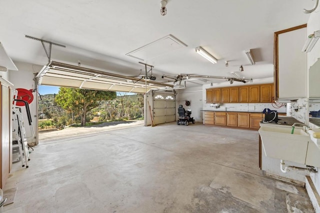 garage with a sink and a garage door opener