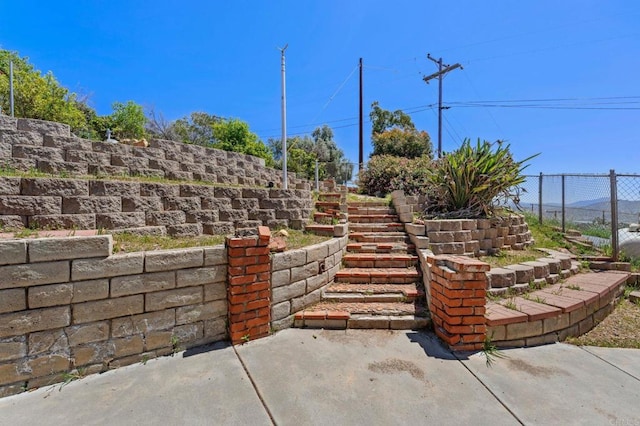 view of patio / terrace with fence and stairs