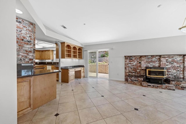 kitchen with open shelves, dark countertops, a wood stove, light tile patterned floors, and open floor plan