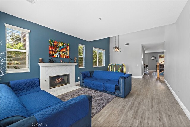 5332 Trailhawk Ave, Fontana, CA 92336 - living room featuring plenty of natural light, visible vents, wood finished floors, and a tile fireplace