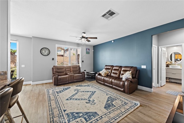 5332 Trailhawk Ave, Fontana, CA 92336 - living room featuring a ceiling fan, baseboards, visible vents, and plenty of natural light