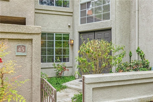 doorway to property with stucco siding