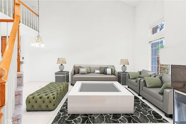 living area with a high ceiling and a notable chandelier