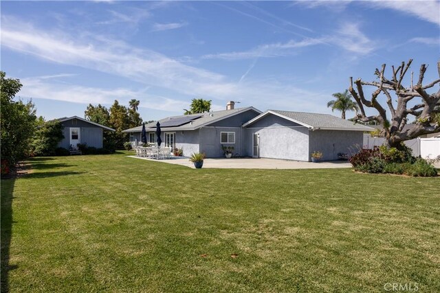1709 S Helen Ave, Ontario, CA 91762 - view of front facade featuring solar panels, a chimney, a front yard, and a patio