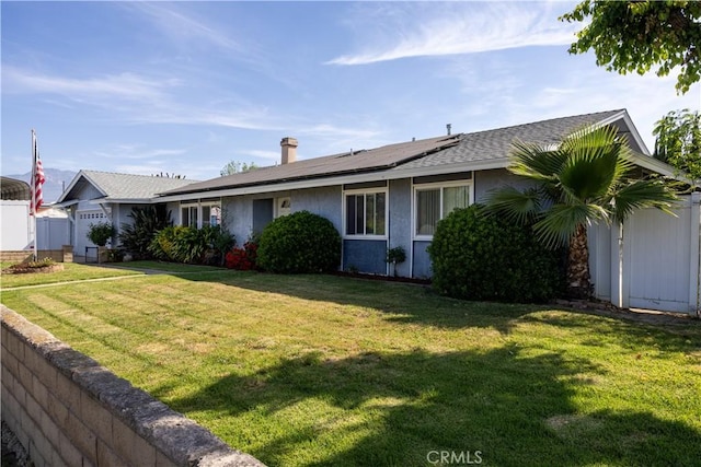 1709 S Helen Ave, Ontario, CA 91762 - ranch-style house featuring stucco siding, roof mounted solar panels, fence, and a front yard