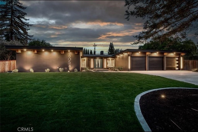 6054 N Kavanagh Ave, Fresno, CA 93711 - contemporary home with an attached garage, fence, a yard, and driveway