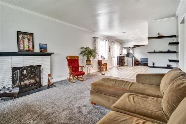 living area with ornamental molding, a brick fireplace, baseboards, carpet floors, and recessed lighting