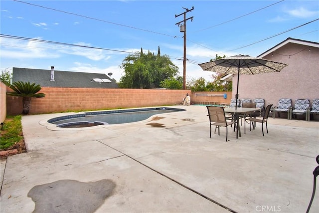 view of pool with a fenced backyard, a patio area, and outdoor dining space