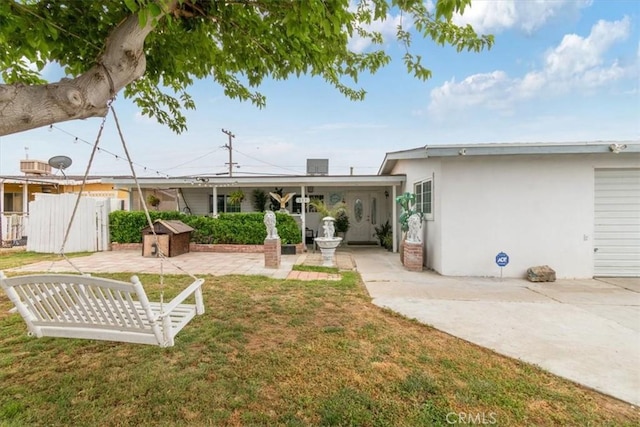 back of property featuring stucco siding, a yard, a patio area, and fence