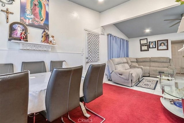 dining area featuring a wainscoted wall, vaulted ceiling, and ceiling fan