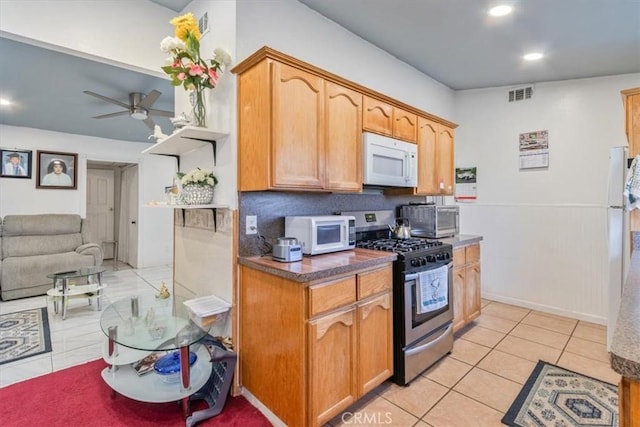 kitchen featuring visible vents, ceiling fan, white appliances, and light tile patterned floors
