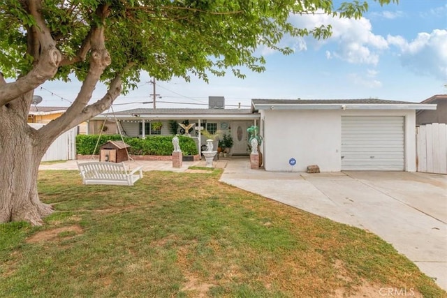 view of front of house with an attached garage, fence, a front yard, and concrete driveway