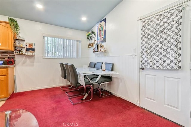 dining space with recessed lighting and carpet