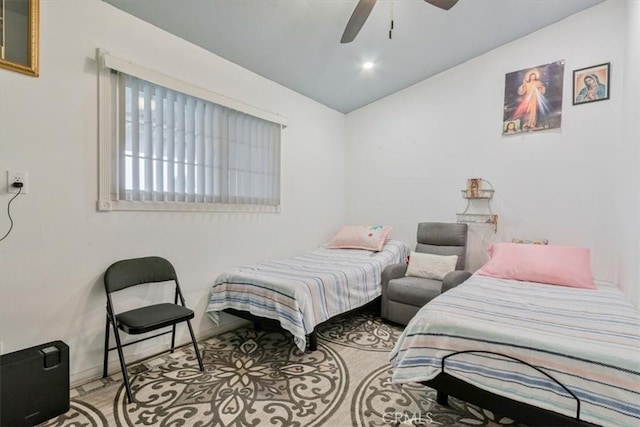 bedroom featuring vaulted ceiling, baseboards, and ceiling fan