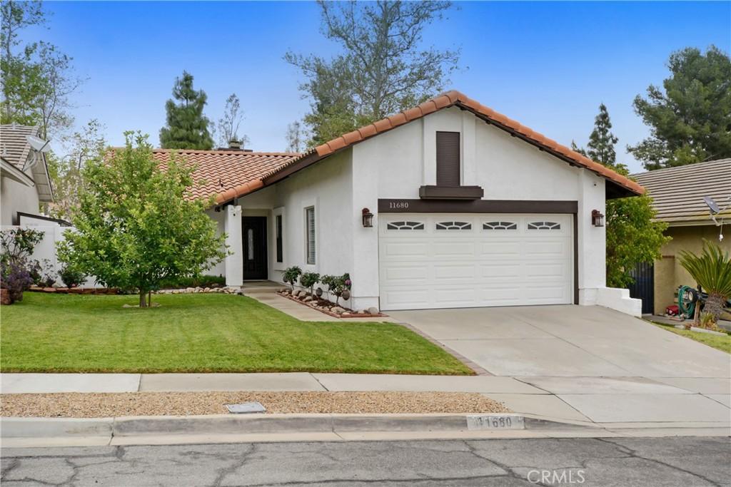 11680 Mount Sterling Ct, Rancho Cucamonga, CA 91737 - view of front of property with concrete driveway, an attached garage, a tiled roof, and stucco siding