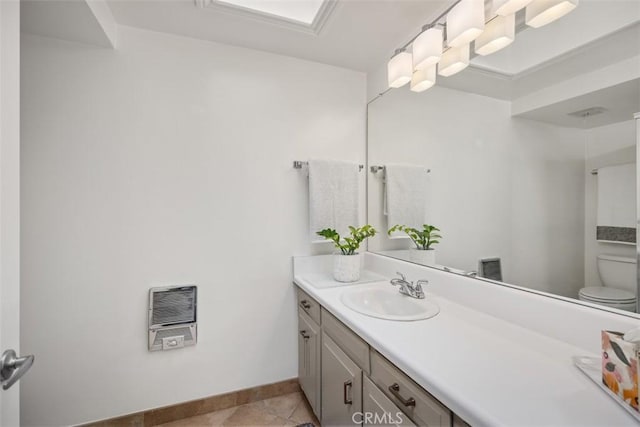 15 Via Castilla Unit T, Laguna Woods, CA 92637 - bathroom with heating unit, toilet, vanity, baseboards, and tile patterned floors