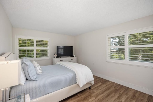 15 Via Castilla Unit T, Laguna Woods, CA 92637 - bedroom featuring multiple windows, wood finished floors, baseboards, and a textured ceiling