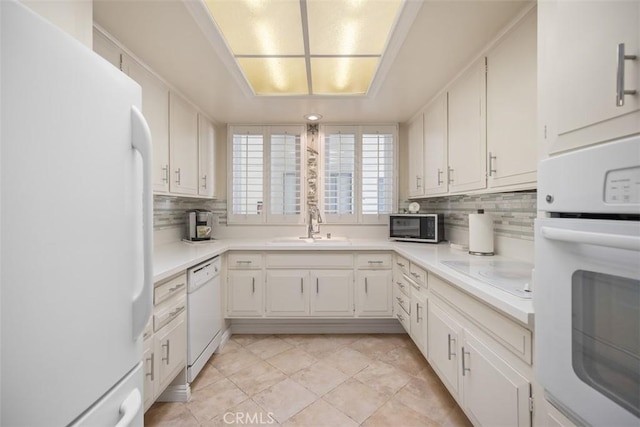 15 Via Castilla Unit T, Laguna Woods, CA 92637 - kitchen with white appliances, a sink, tasteful backsplash, and light countertops