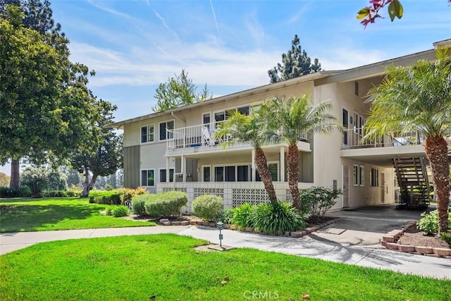15 Via Castilla Unit T, Laguna Woods, CA 92637 - view of front facade with stucco siding, a front lawn, a carport, and driveway