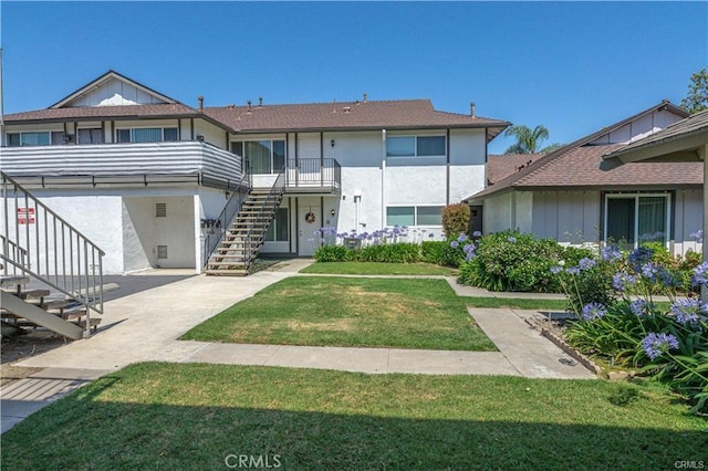 2625 W Orion Ave, Santa Ana, CA 92704 - view of front of home with stucco siding, a patio, stairs, and a front yard