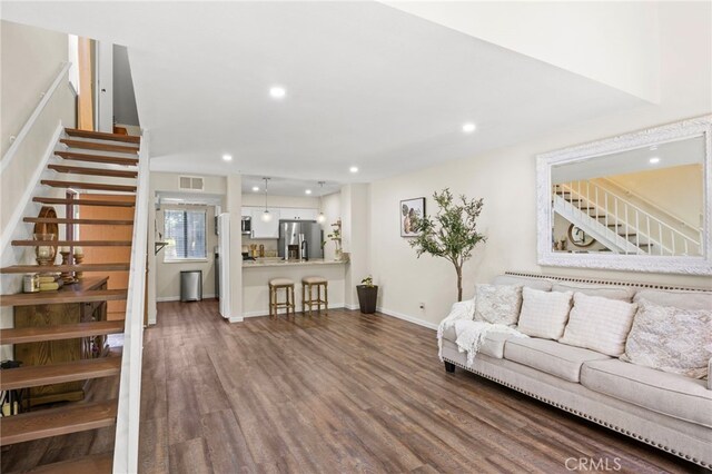 14133 Bayside Dr, Norwalk, CA 90650 - living room with dark wood-type flooring, stairway, recessed lighting, and baseboards