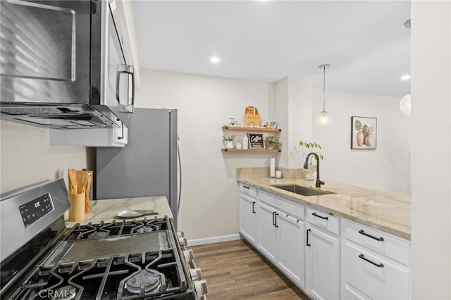 14133 Bayside Dr, Norwalk, CA 90650 - kitchen featuring stainless steel appliances, a sink, white cabinets, light stone counters, and dark wood-style flooring