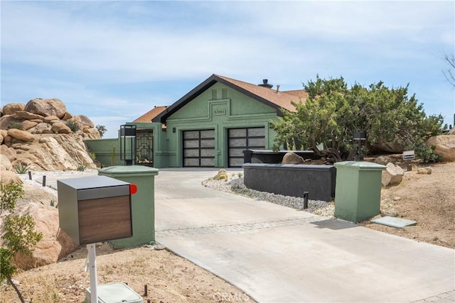 57093 Monticello Ct, Yucca Valley, CA 92284 - exterior space with an attached garage, driveway, and stucco siding