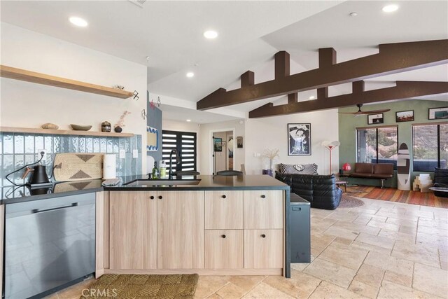 57093 Monticello Ct, Yucca Valley, CA 92284 - kitchen with stainless steel dishwasher, dark countertops, a sink, open floor plan, and light brown cabinetry
