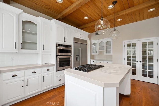 kitchen featuring dark wood-style floors, beamed ceiling, glass insert cabinets, wood ceiling, and appliances with stainless steel finishes