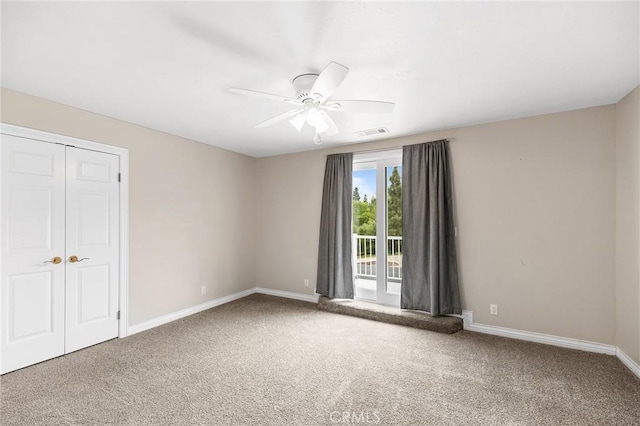 unfurnished bedroom featuring visible vents, a closet, baseboards, carpet flooring, and ceiling fan