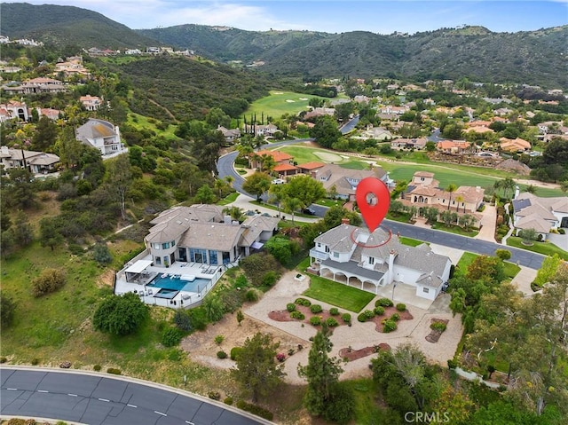 drone / aerial view with a residential view, view of golf course, and a mountain view