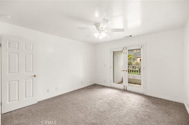 carpeted empty room featuring ceiling fan, baseboards, and visible vents