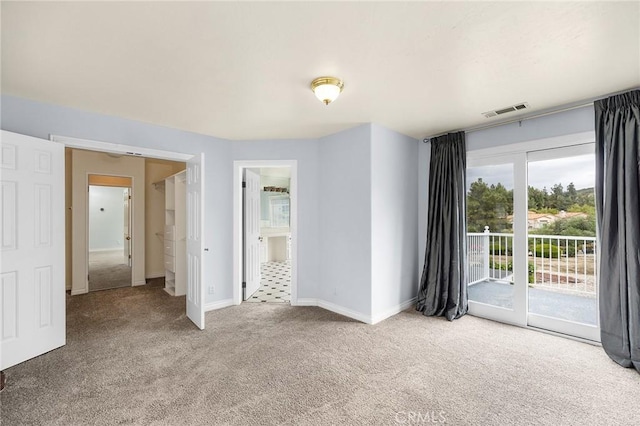 interior space with baseboards, visible vents, and carpet floors