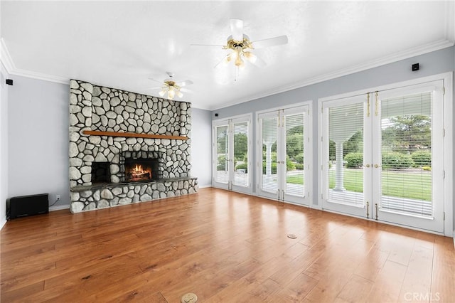 unfurnished living room featuring a ceiling fan, wood finished floors, and crown molding