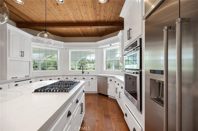 kitchen featuring wood ceiling, appliances with stainless steel finishes, white cabinetry, and light countertops