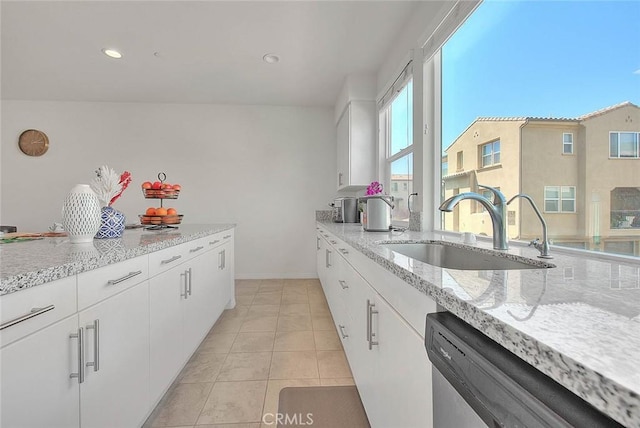 803 N Dalton Ave, Azusa, CA 91702 - kitchen featuring light stone countertops, stainless steel dishwasher, a sink, and white cabinetry