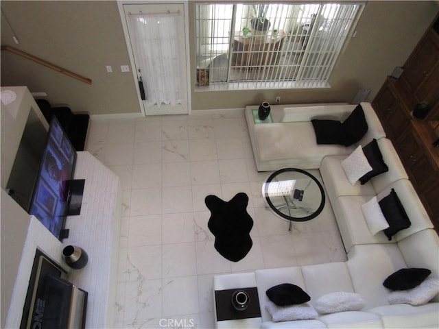 living room with marble finish floor and baseboards