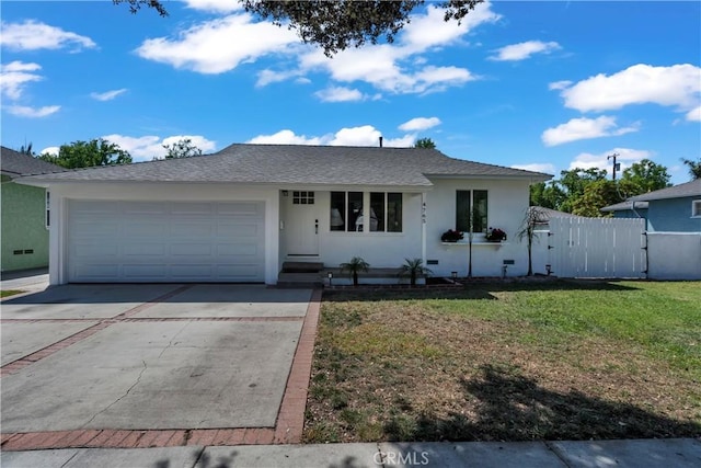ranch-style house with fence, concrete driveway, an attached garage, stucco siding, and a front yard