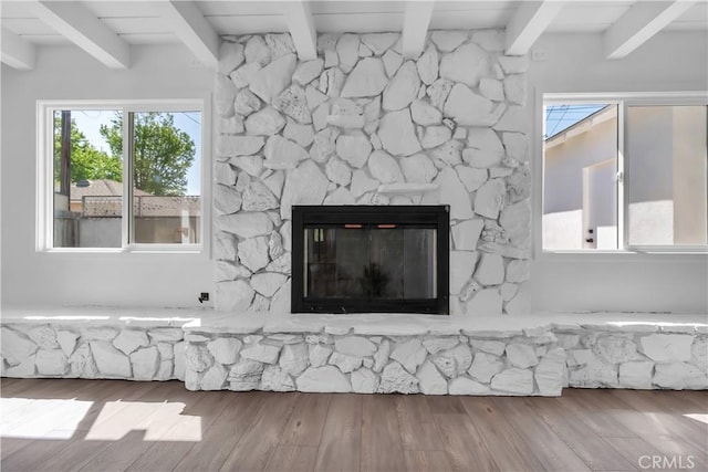 details with beamed ceiling, wood finished floors, and a fireplace