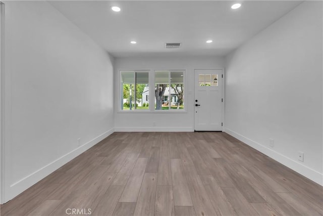 interior space with recessed lighting, wood finished floors, and baseboards