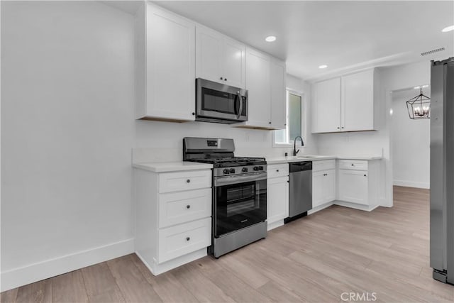 kitchen featuring visible vents, baseboards, a sink, and appliances with stainless steel finishes