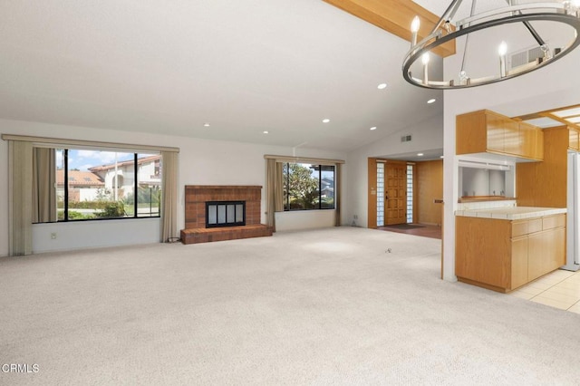 unfurnished living room featuring plenty of natural light, a fireplace, recessed lighting, and light colored carpet