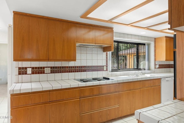 kitchen with a sink, light tile patterned flooring, tasteful backsplash, electric stovetop, and dishwasher