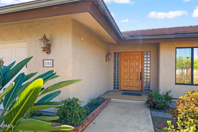 property entrance with stucco siding