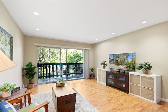 living room with recessed lighting, wood finished floors, and baseboards