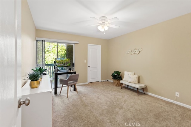 living area featuring carpet, baseboards, and ceiling fan