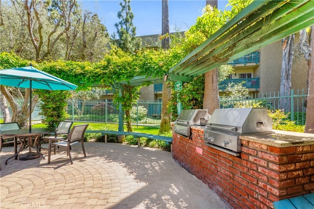 view of patio / terrace featuring area for grilling and fence