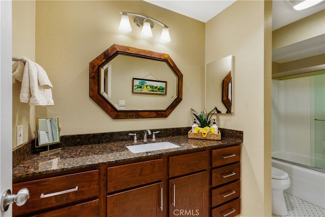 bathroom with bath / shower combo with glass door, toilet, vanity, and tile patterned floors